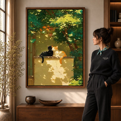 Garden cats canvas art displayed in a walnut frame against a warm wall near a wooden console.