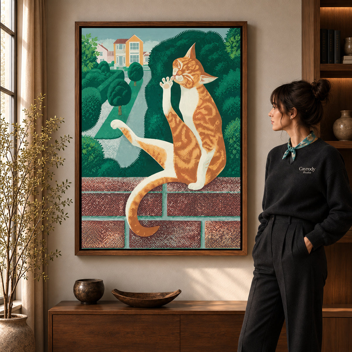 Garden tabby canvas art displayed in a walnut frame against a warm wall near a wooden console.