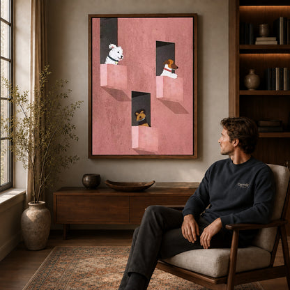 Window dogs canvas art above a wooden console near a seated man and leafy branches.