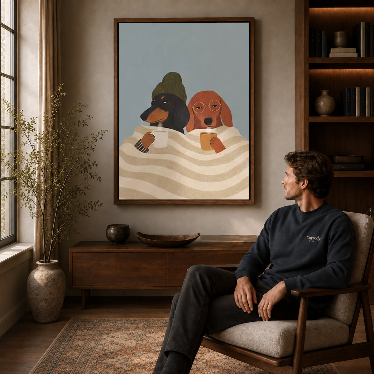 Cozy Coffee Dogs canvas art above a wooden console beside a seated man in a warm room.