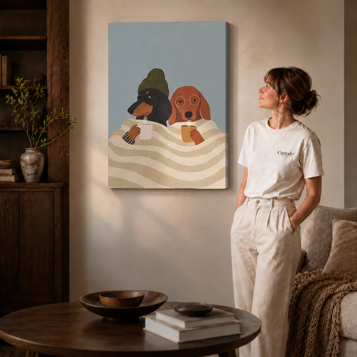 Cozy Coffee Dogs canvas art displayed as gallery wrapped canvas beside a woman in natural light.