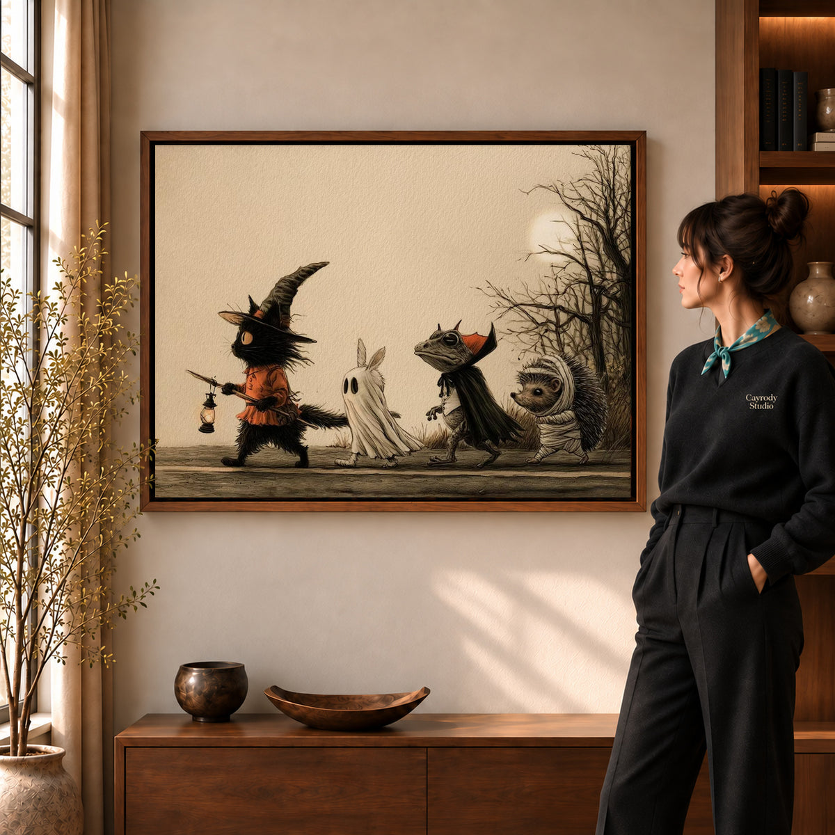 Walnut framed halloween parade canvas art shown beside a standing woman and a wooden console.