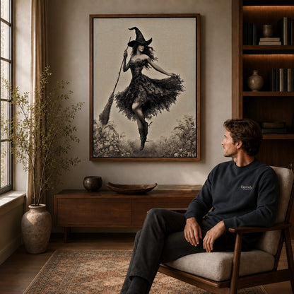 Dancing Witch canvas art above a wooden console beside a seated man in a warm room.