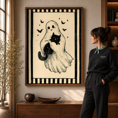 Ghost And Cat canvas art in a walnut frame beside a standing woman and wooden console.