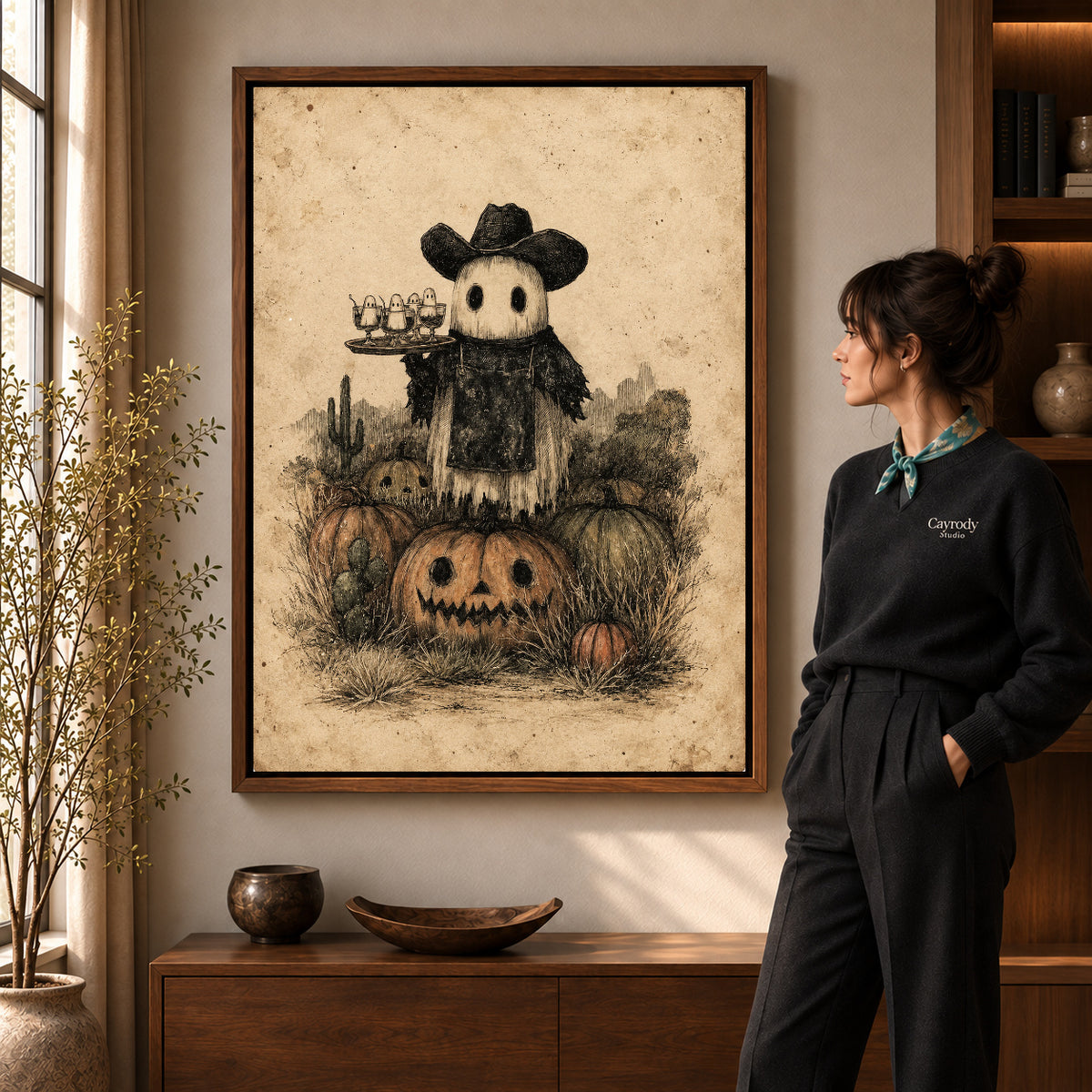 Walnut framed ghost cowboy canvas art shown beside a standing woman and a wooden console.
