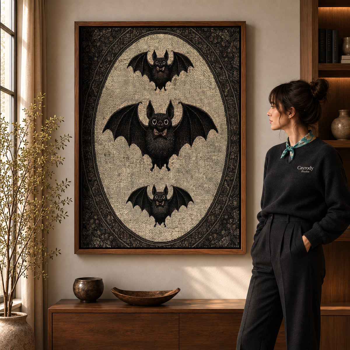 Vintage Bat canvas art in a walnut frame beside a standing woman and wooden console.