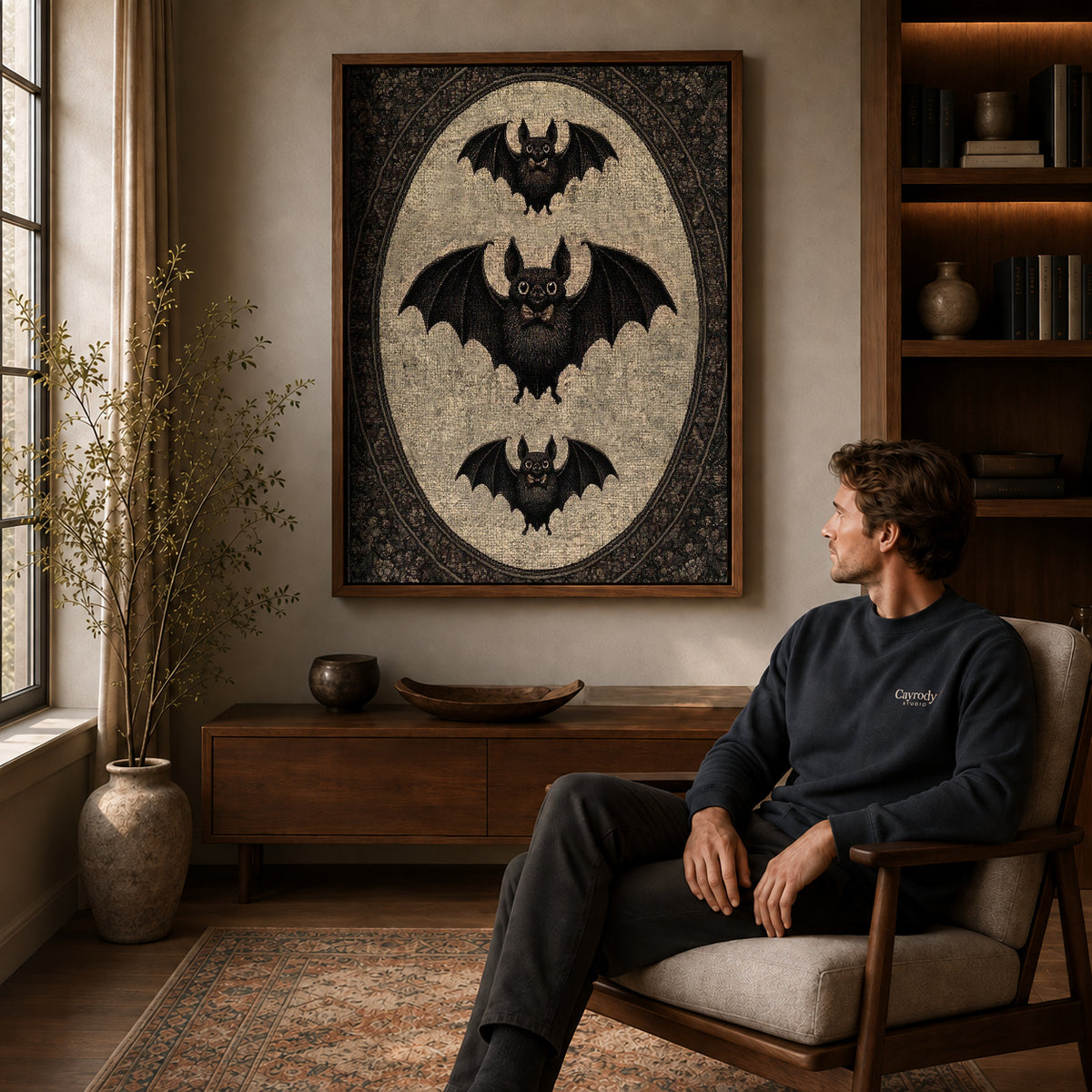 Vintage Bat canvas art above a wooden console beside a seated man in a warm room.