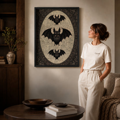 Black framed vintage bat canvas art displayed beside a woman in a warm living room.