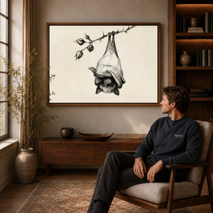 Hanging Bat canvas art above a wooden console beside a seated man in a warm room.