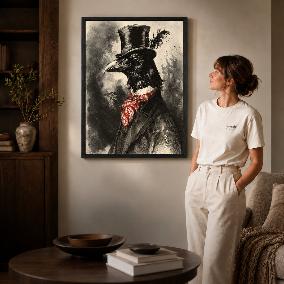 Dapper Raven canvas art in a black frame above books in a welcoming living room.