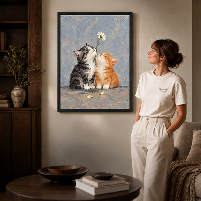 Daisy Kittens canvas art in a black frame above books in a welcoming living room.
