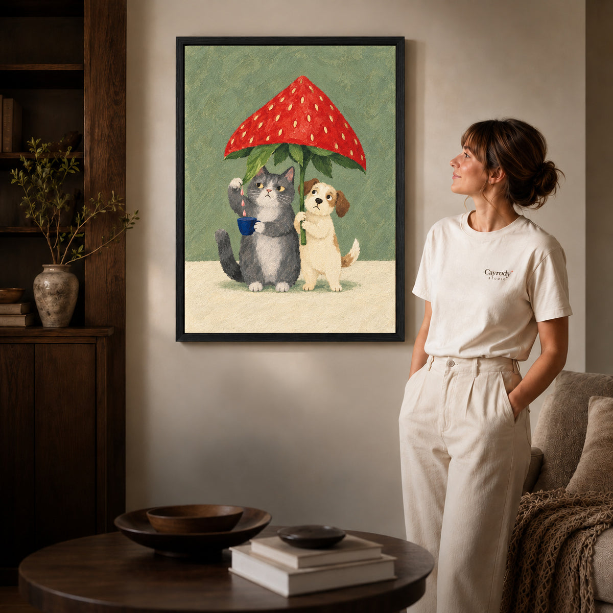 Strawberry Umbrella canvas art in a black frame above books in a welcoming living room.