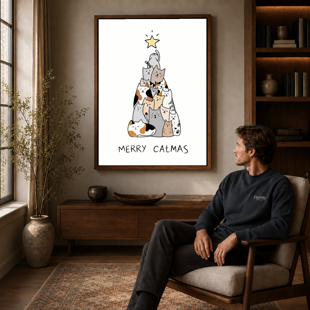 Cat Christmas canvas art above a wooden console beside a seated man in a warm room.