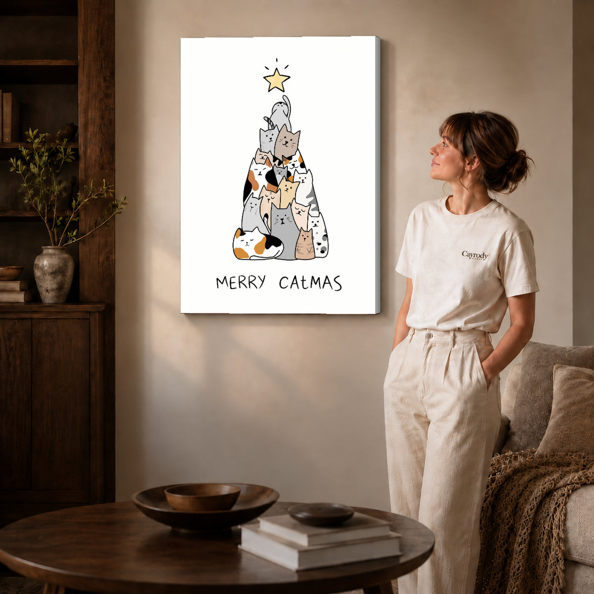 Gallery wrapped cat christmas canvas art with visible canvas edges beside a standing woman.