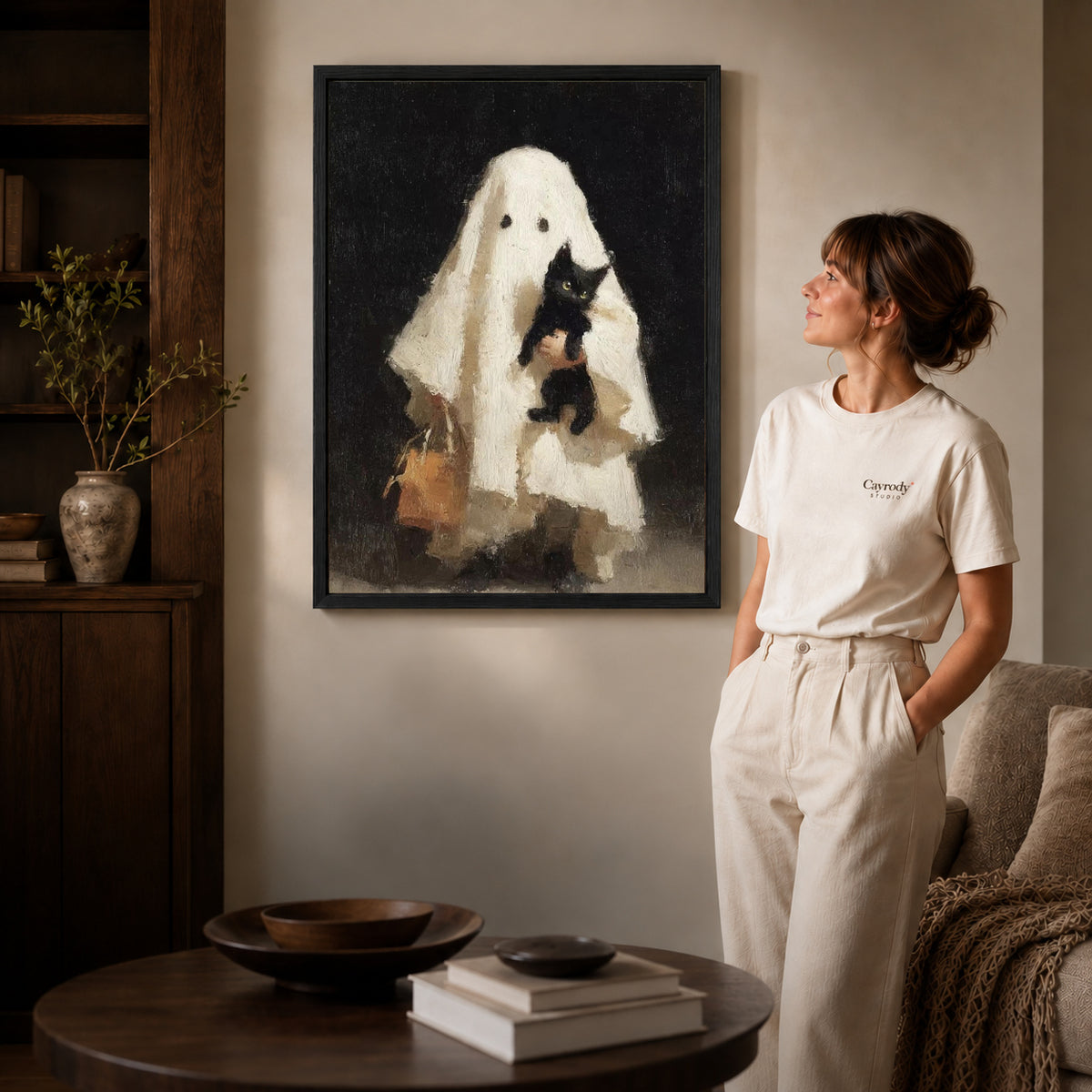 Gentle Ghost canvas art in a black frame above books in a welcoming living room.