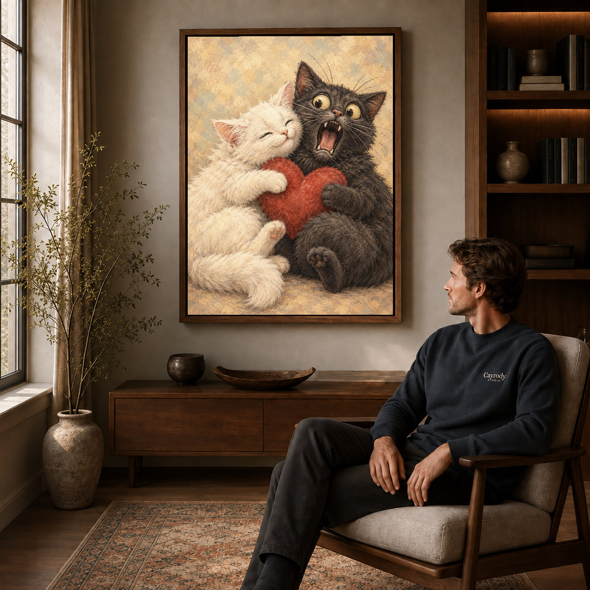 Cat Love canvas art above a wooden console beside a seated man in a warm room.