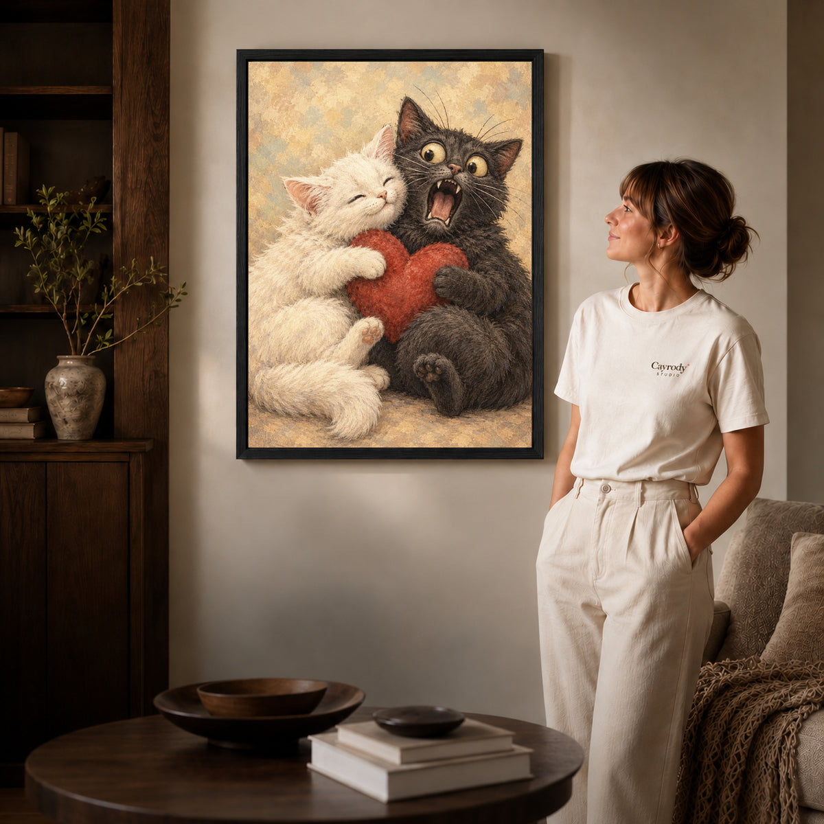Cat Love canvas art in a black frame above books in a welcoming living room.