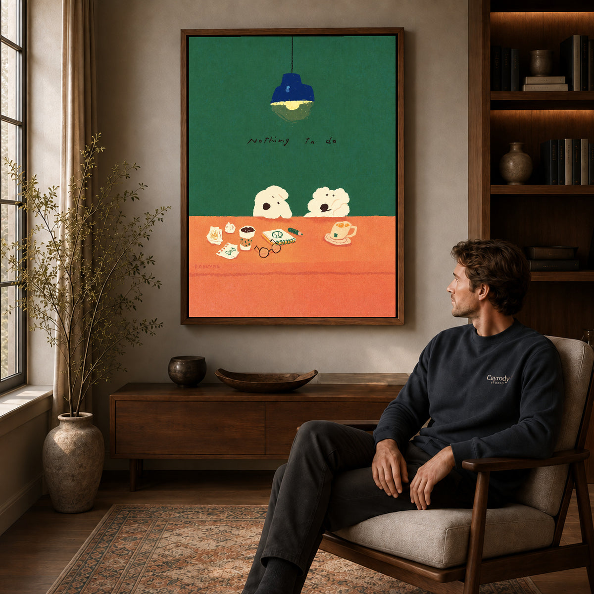 Idle Desk Dogs canvas art above a wooden console beside a seated man in a warm room.