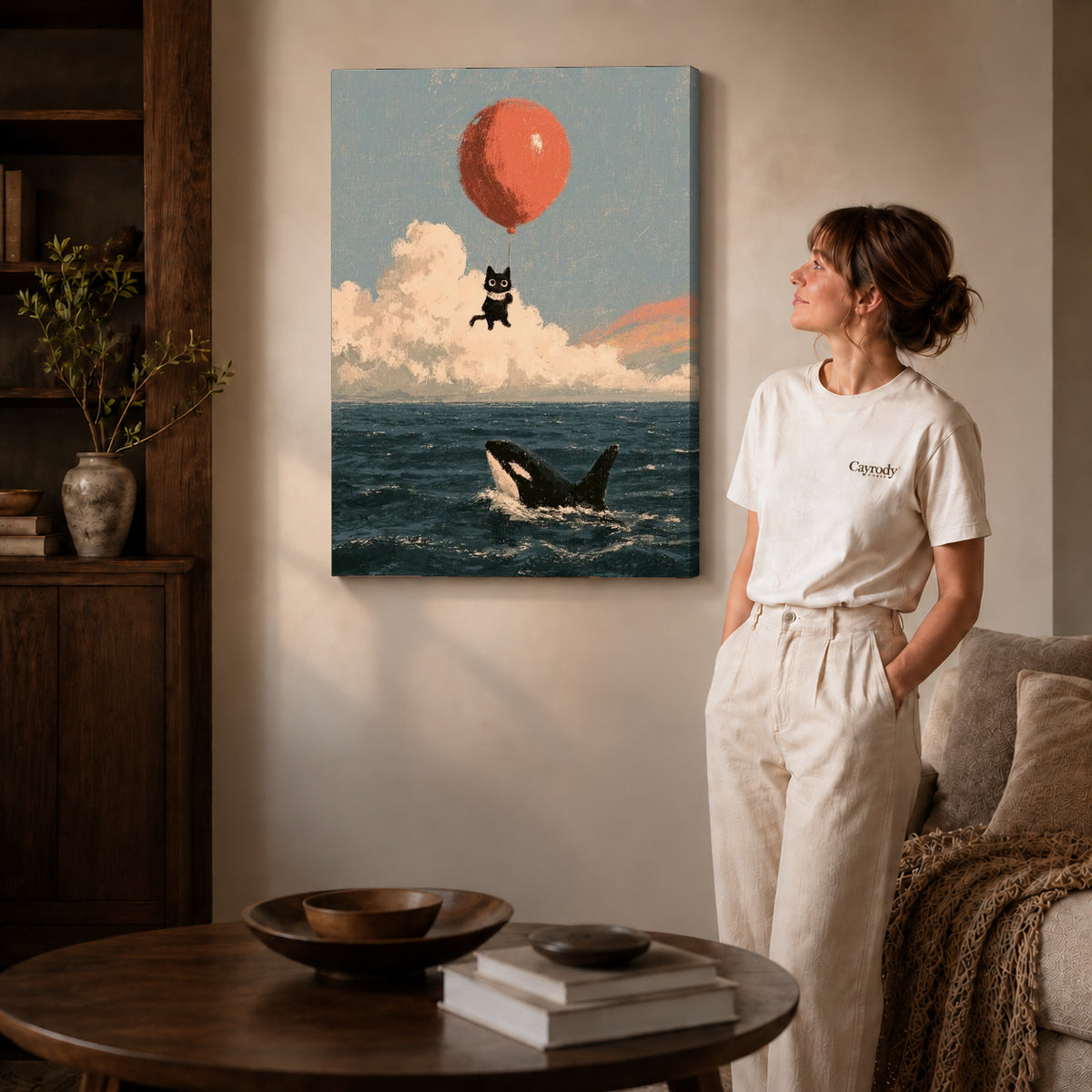 Gallery wrapped balloon cat canvas art with visible canvas edges beside a standing woman.