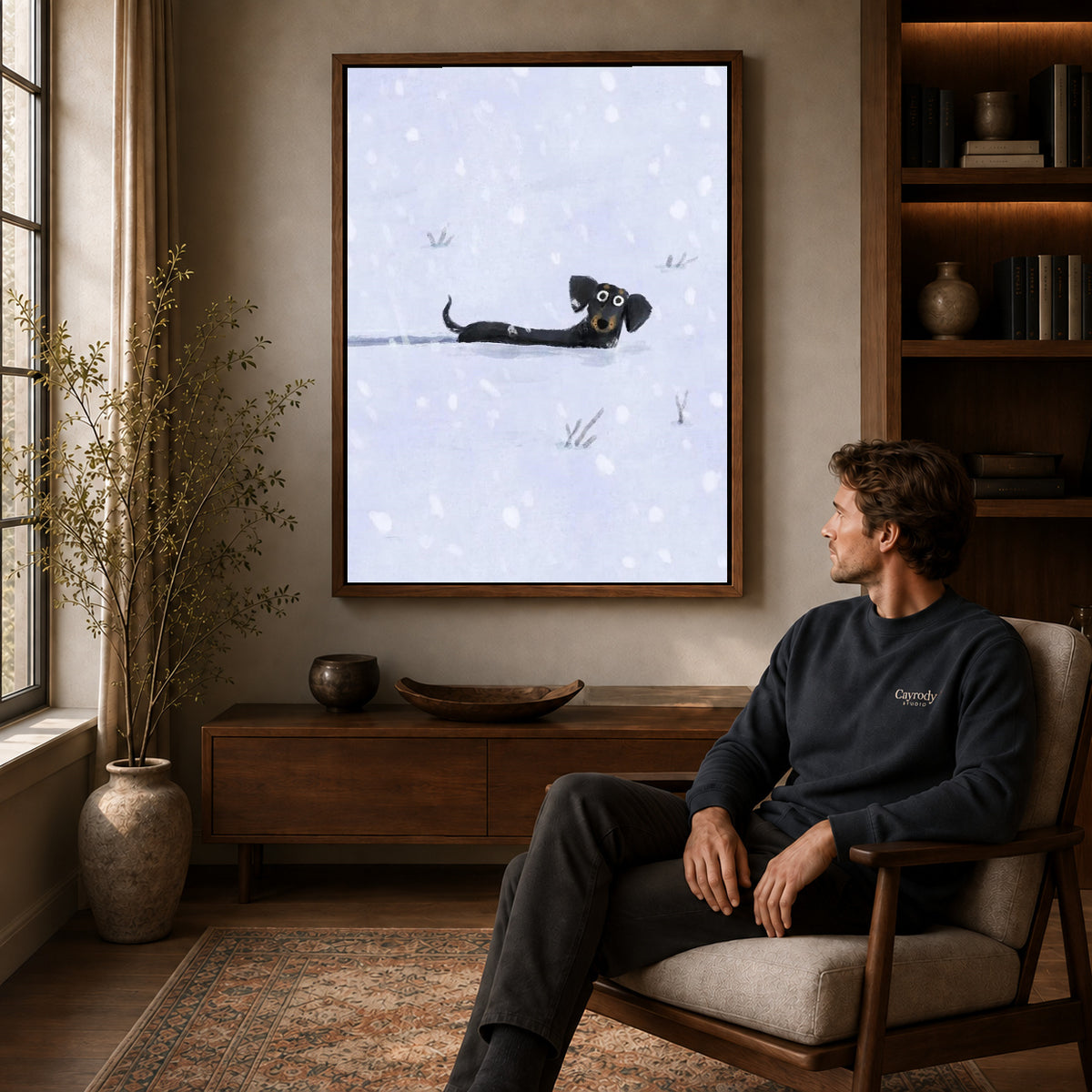 Snowy Dachshund canvas art above a wooden console beside a seated man in a warm room.