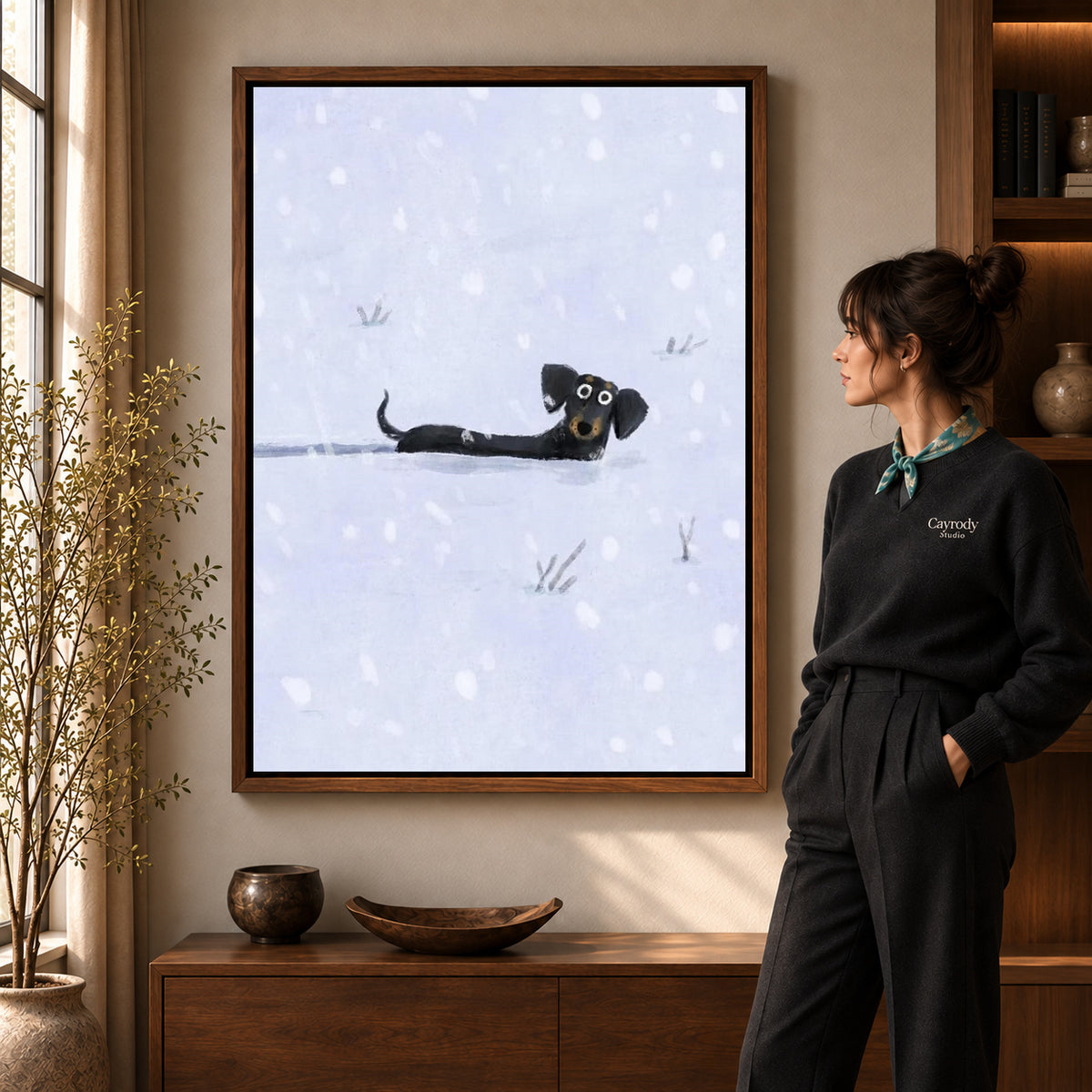 Walnut framed snowy dachshund canvas art shown beside a standing woman and a wooden console.