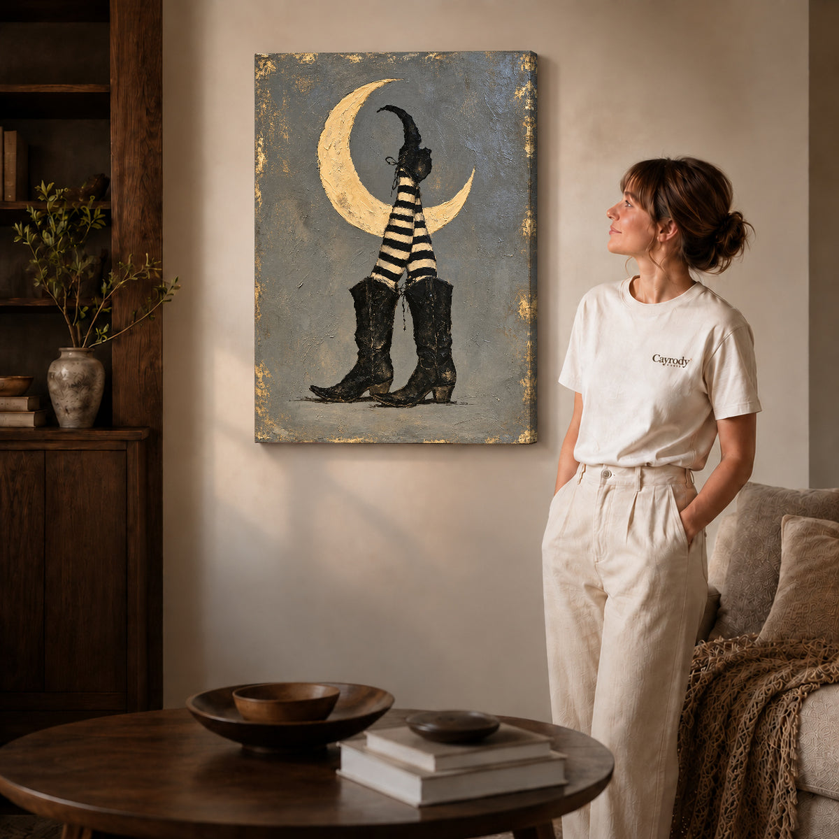 Moonlit Witch Boots canvas art displayed as gallery wrapped canvas beside a woman in natural light.