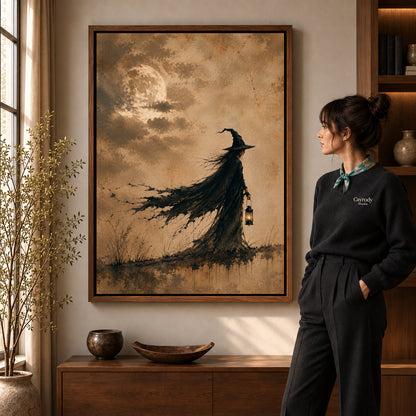 Lantern Witch canvas art in a walnut frame beside a standing woman and wooden console.