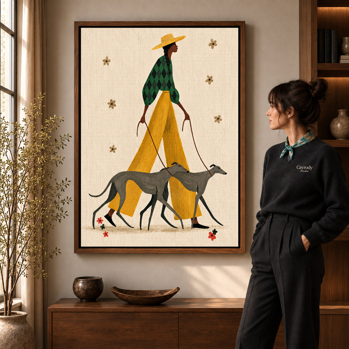 Stylish Greyhound Walk canvas art in a walnut frame beside a standing woman and wooden console.