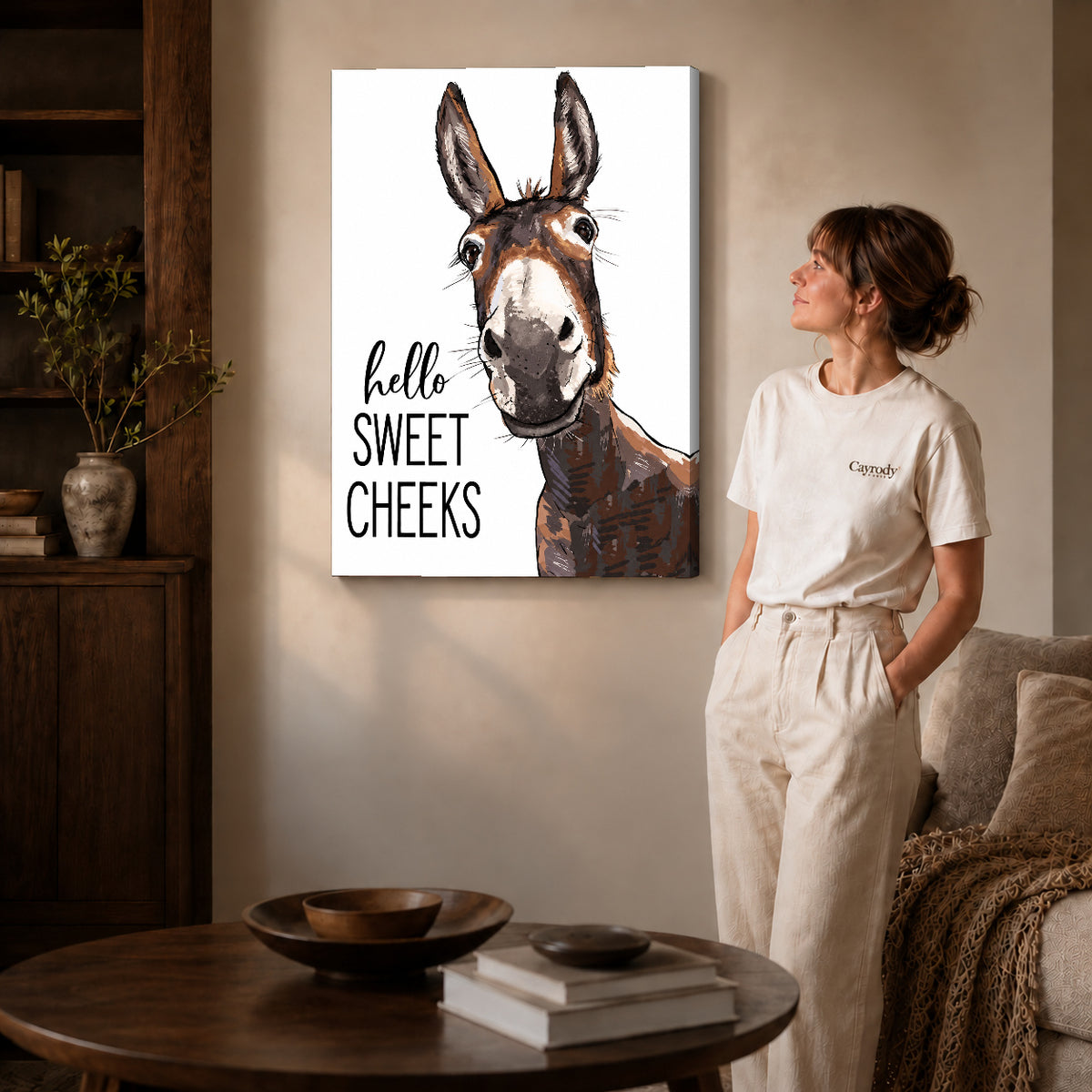 Sweet Cheeks Donkey canvas art displayed as gallery wrapped canvas beside a woman in natural light.