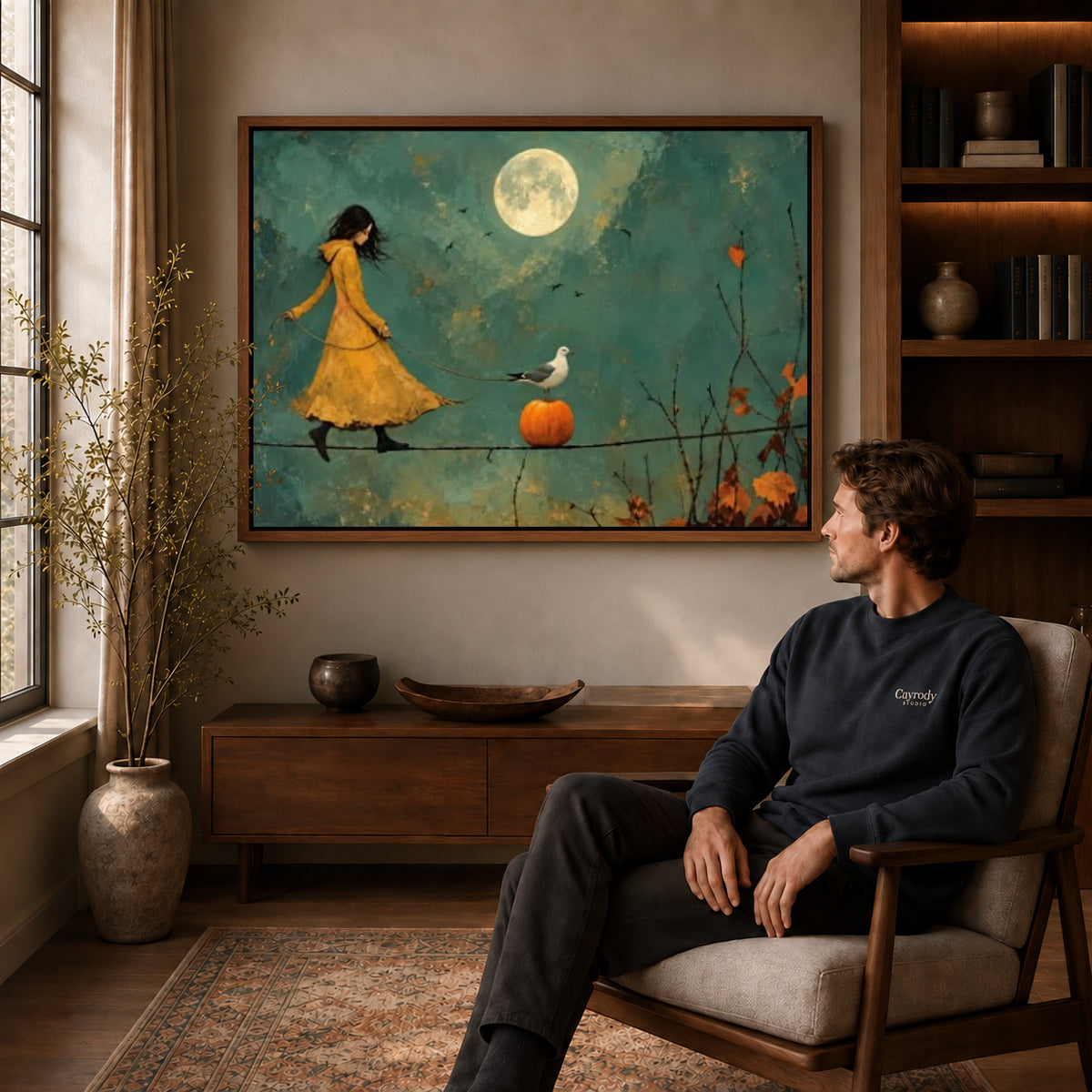 Moonlit Tightrope canvas art above a wooden console beside a seated man in a warm room.