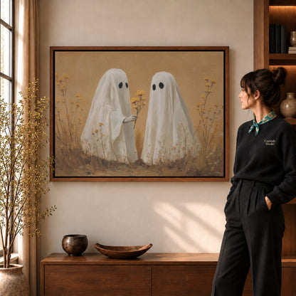 Ghost Flower Gift canvas art in a walnut frame beside a standing woman and wooden console.