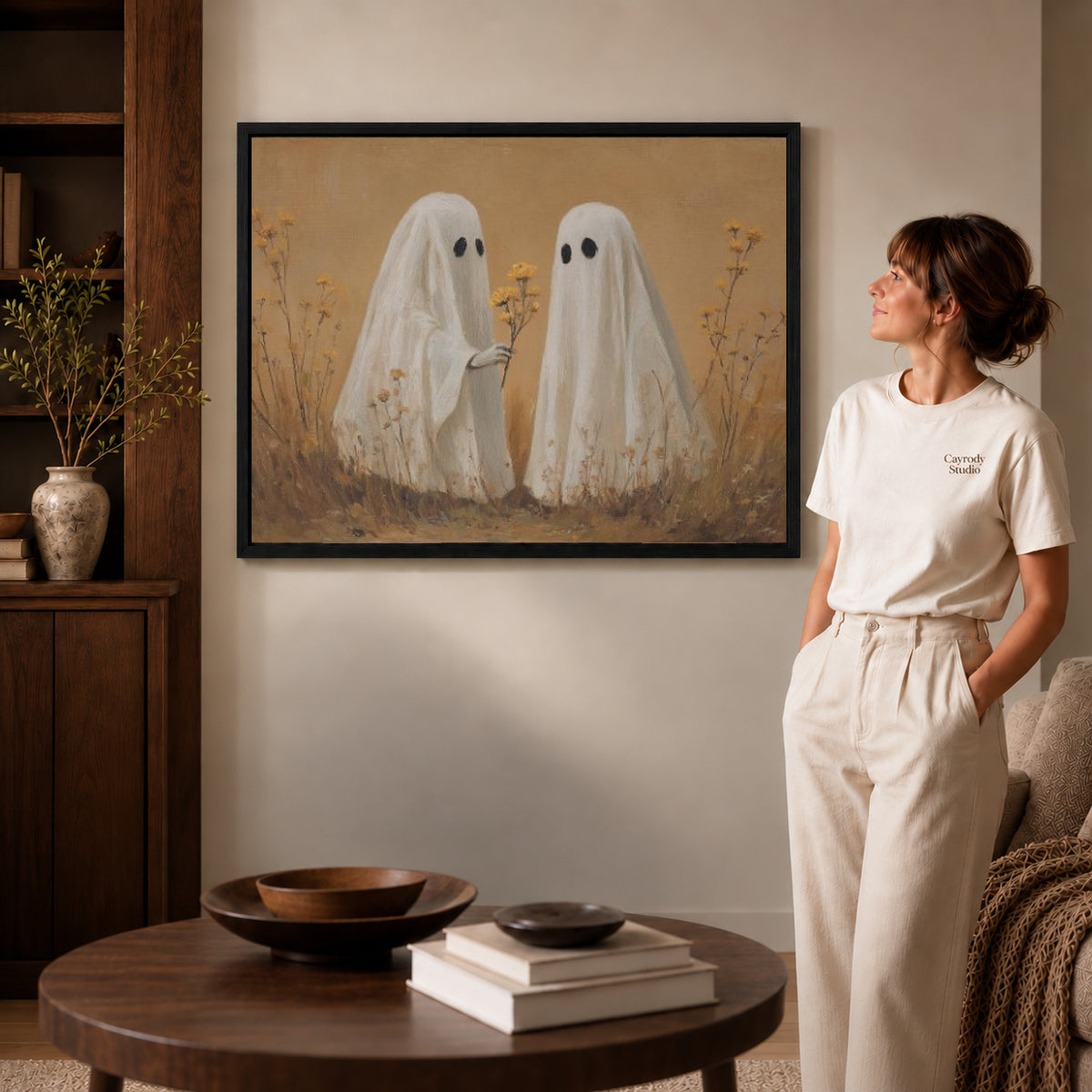 Ghost Flower Gift canvas art in a black frame above books in a welcoming living room.