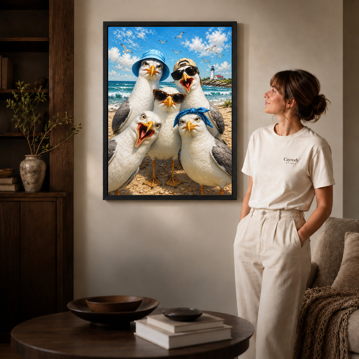 Beach Seagull Selfie canvas art in a black frame above books in a welcoming living room.