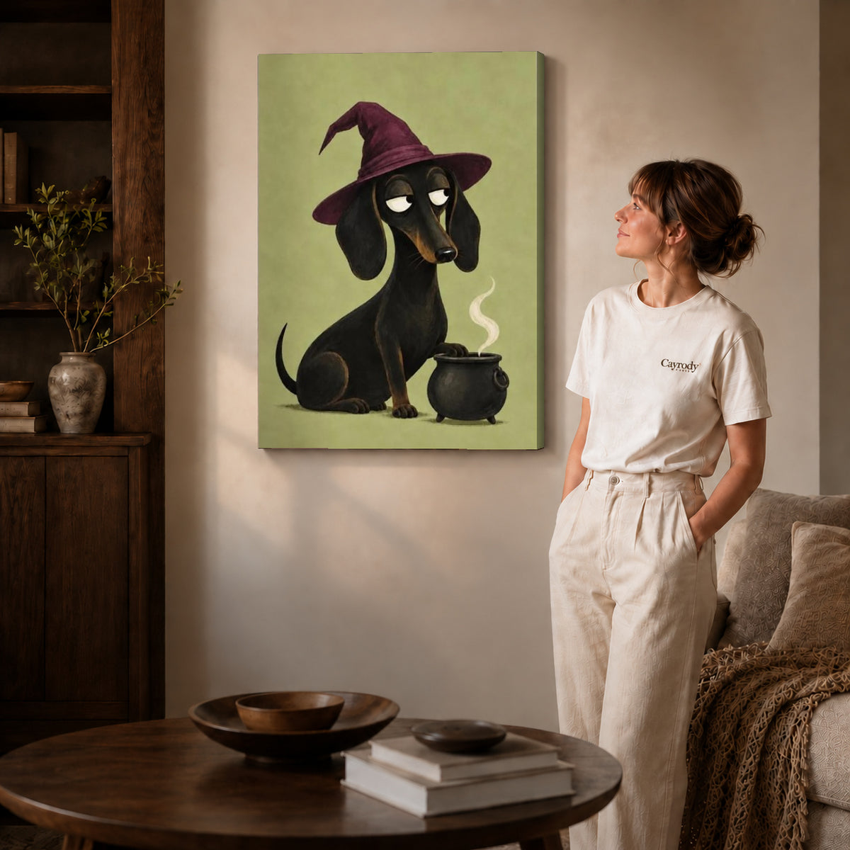 Dachshund Witch canvas art displayed as gallery wrapped canvas beside a woman in natural light.