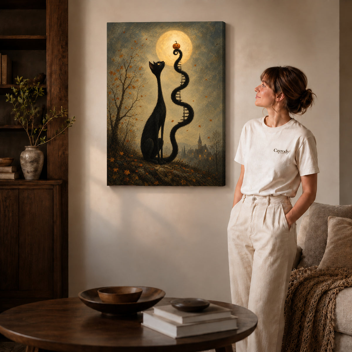Gallery wrapped moon ladder cat canvas art with visible canvas edges beside a standing woman.