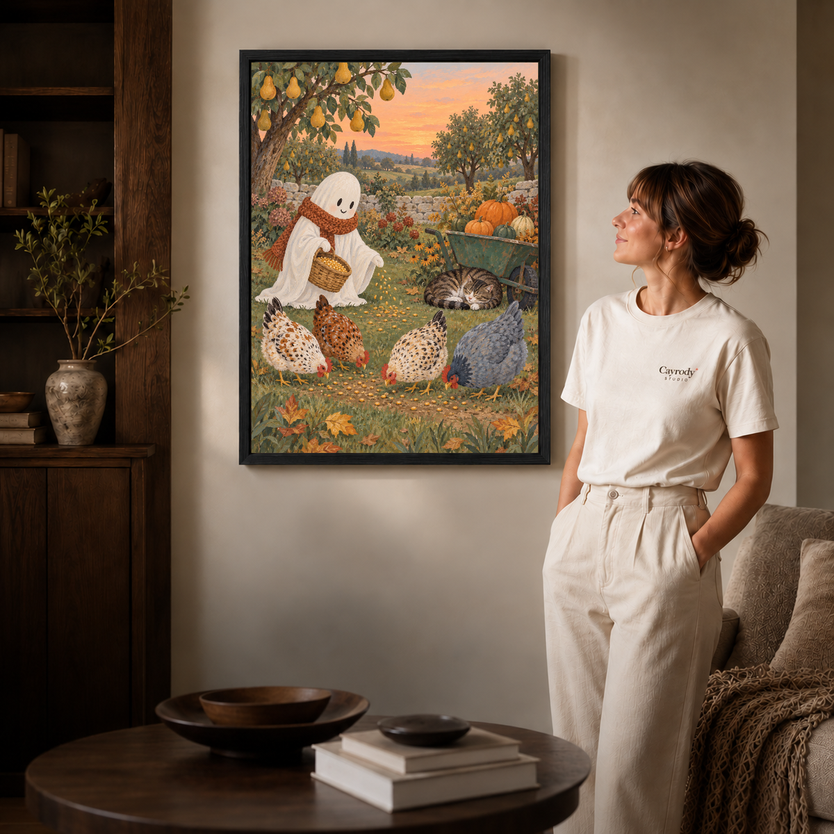 Warm autumn ghost illustration in a black frame beside a woman in a softly lit living room.