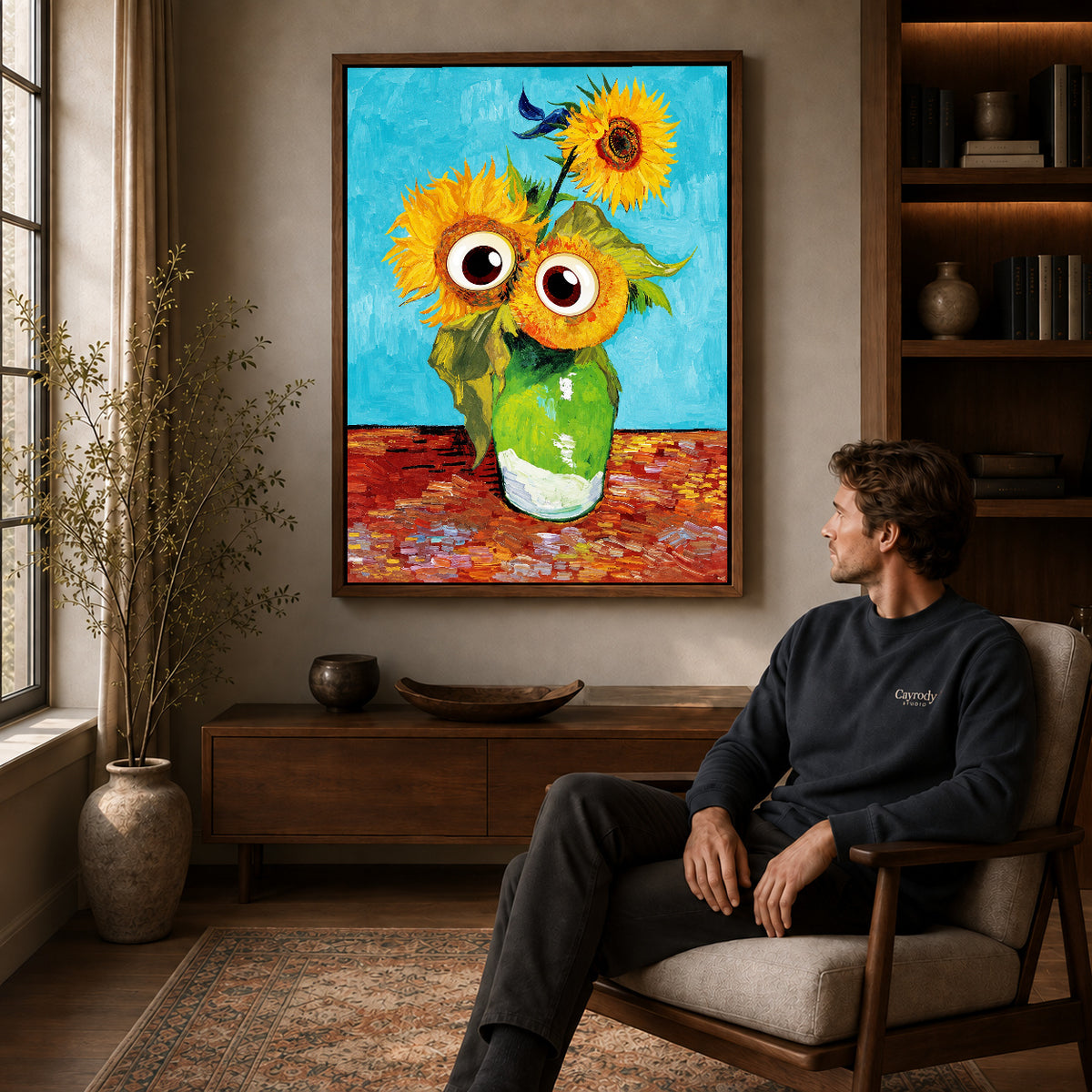 Googly Sunflowers canvas art above a wooden console beside a seated man in a warm room.