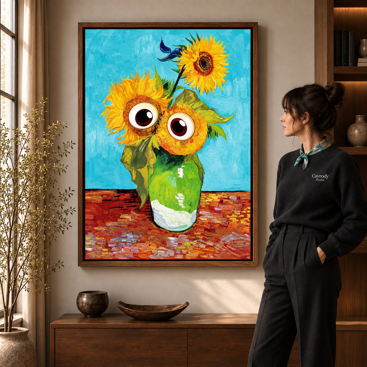 Walnut framed googly sunflowers canvas art shown beside a standing woman and a wooden console.