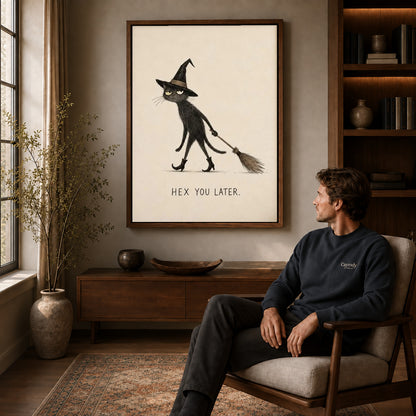 Broomstick Cat canvas art above a wooden console beside a seated man in a warm room.