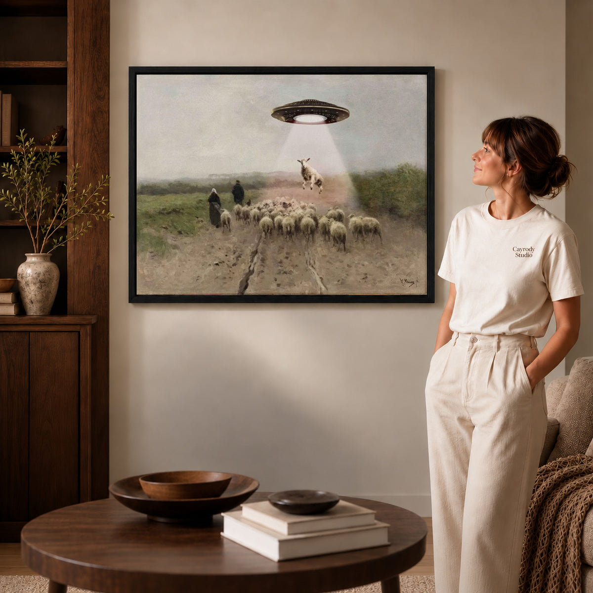 Alien Sheep Visit canvas art in a black frame above books in a welcoming living room.