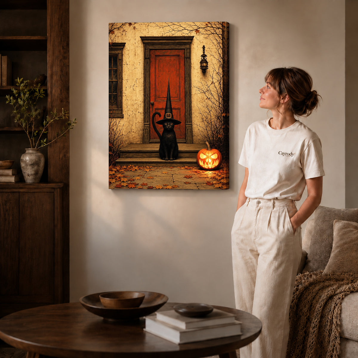 Porch Witch Cat canvas art displayed as gallery wrapped canvas beside a woman in natural light.