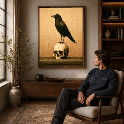 Raven And Skull canvas art above a wooden console beside a seated man in a warm room.