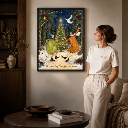 Snow Dance Couple canvas art in a black frame above books in a welcoming living room.