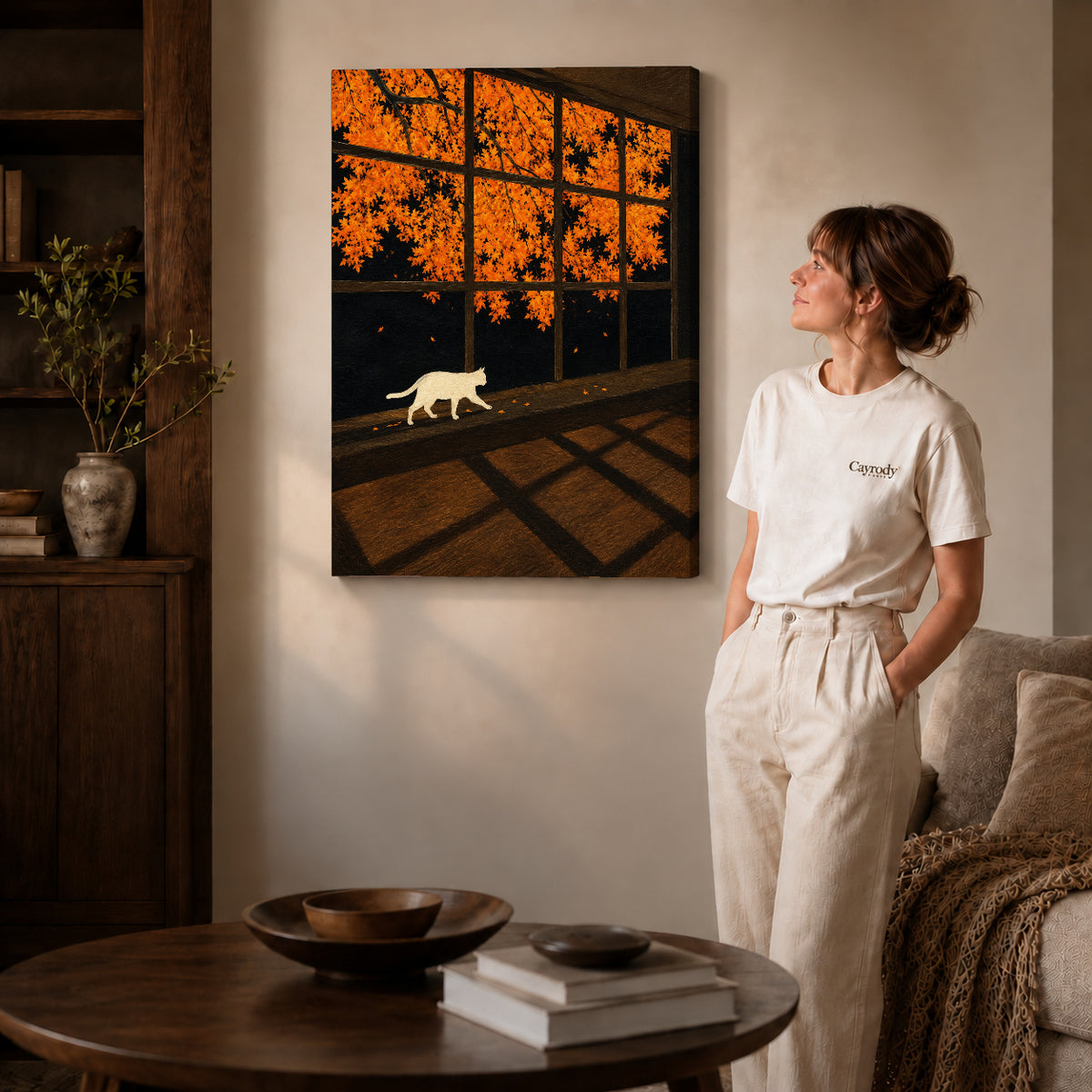 Autumn Window Cat canvas art displayed as gallery wrapped canvas beside a woman in natural light.