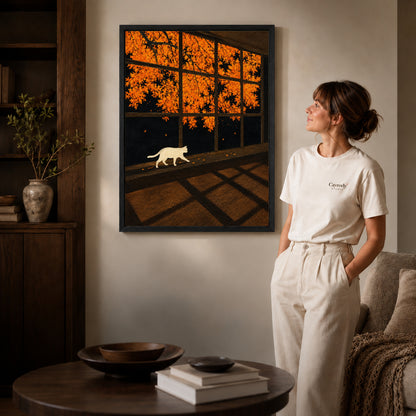 Autumn Window Cat canvas art in a black frame above books in a welcoming living room.