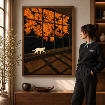 Walnut framed autumn window cat canvas art shown beside a standing woman and a wooden console.