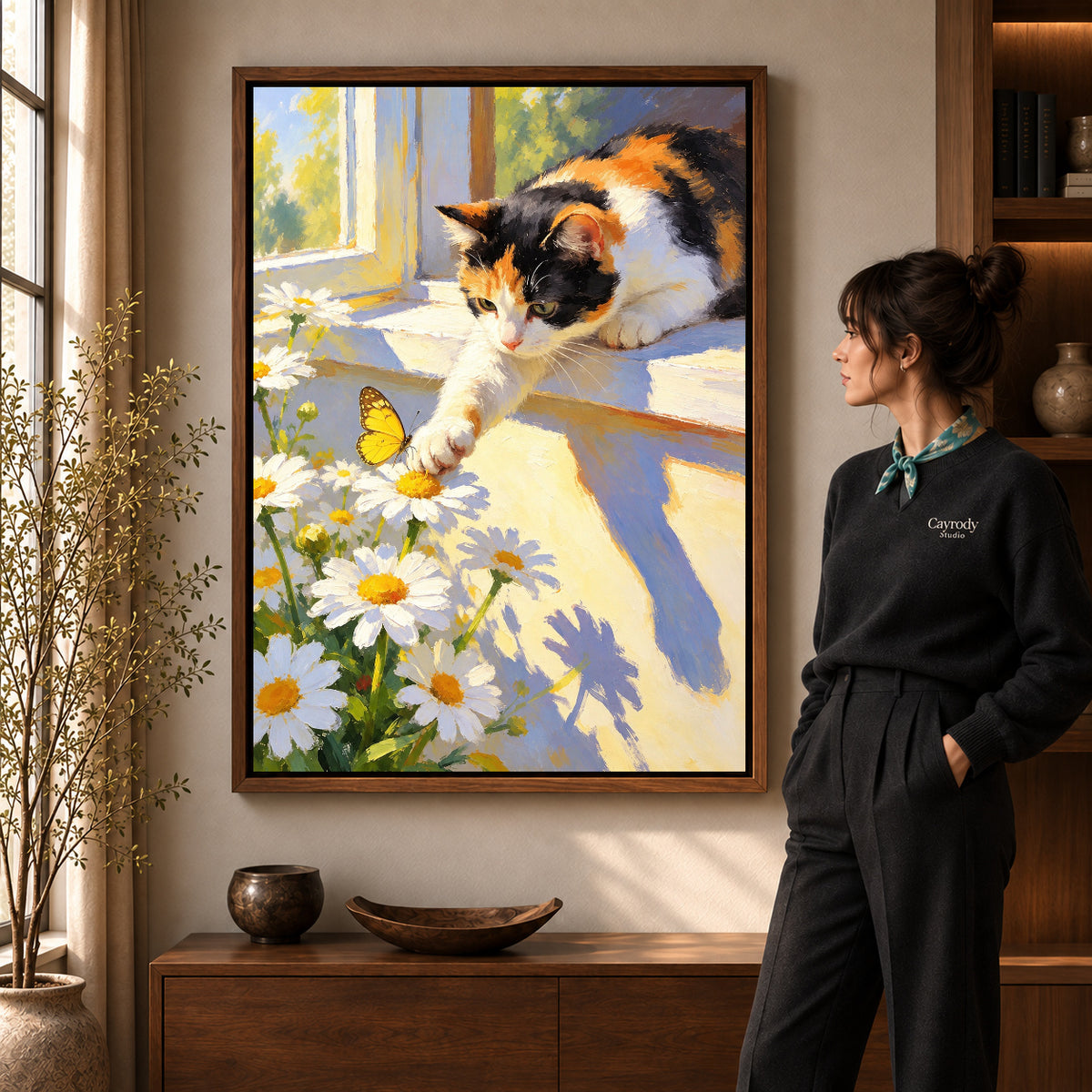 Butterfly Window Cat canvas art in a walnut frame beside a standing woman and wooden console.