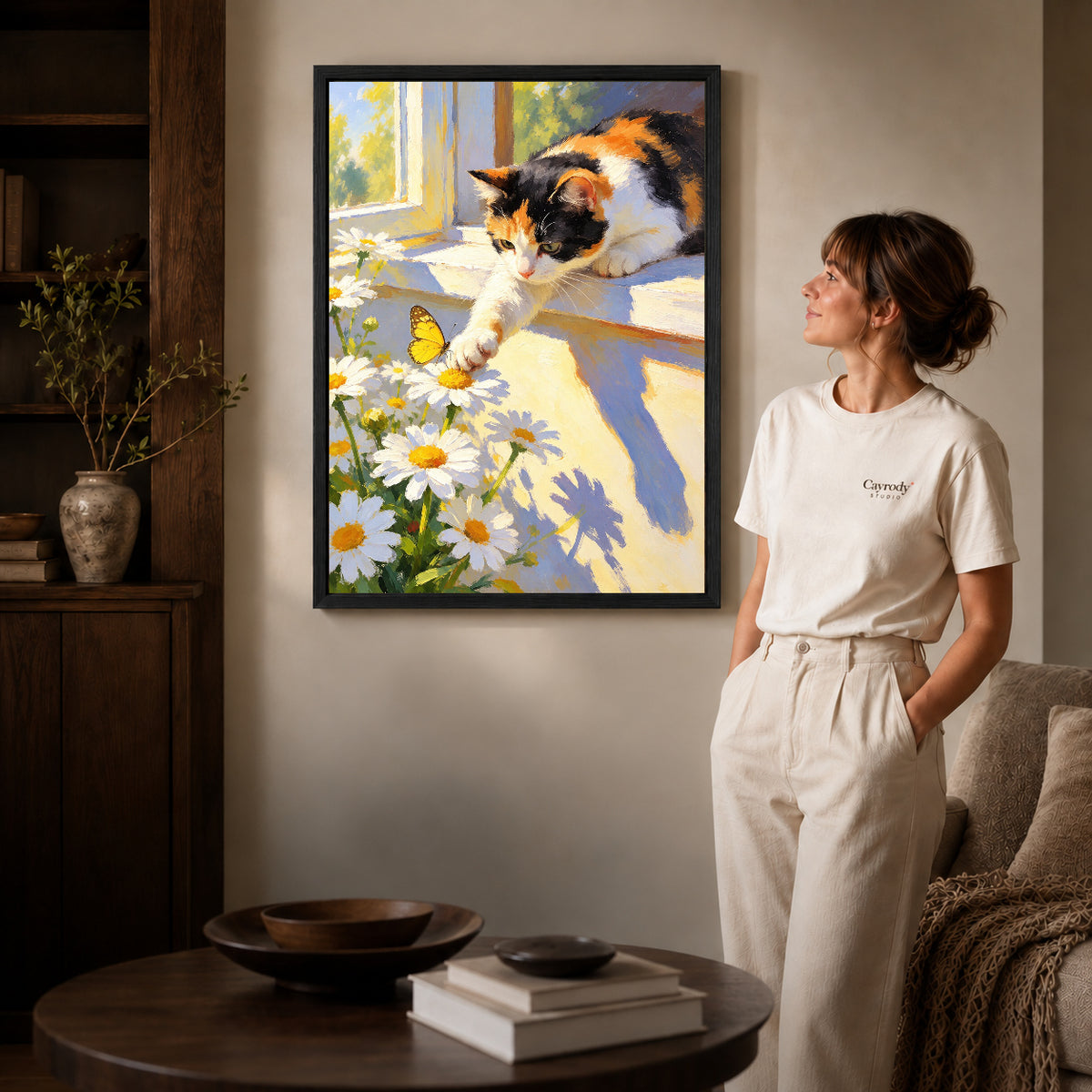 Butterfly Window Cat canvas art in a black frame above books in a welcoming living room.