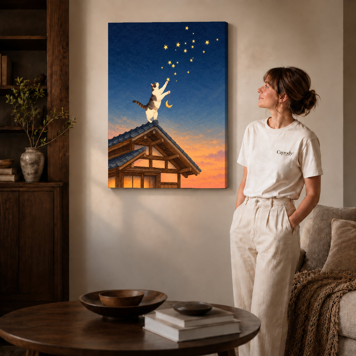 Stargazing Rooftop Cat canvas art displayed as gallery wrapped canvas beside a woman in natural light.