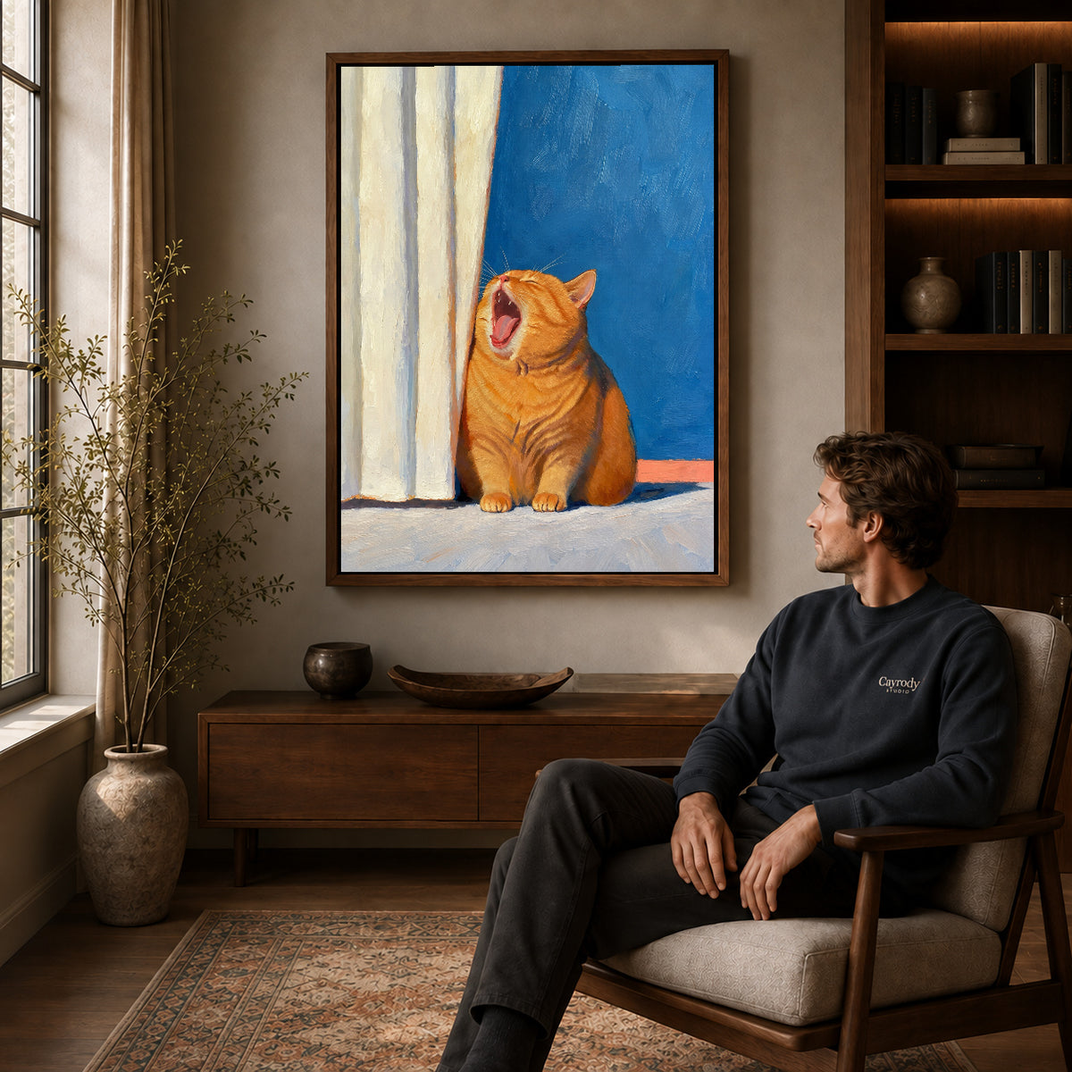 Yawning Orange Cat canvas art above a wooden console beside a seated man in a warm room.